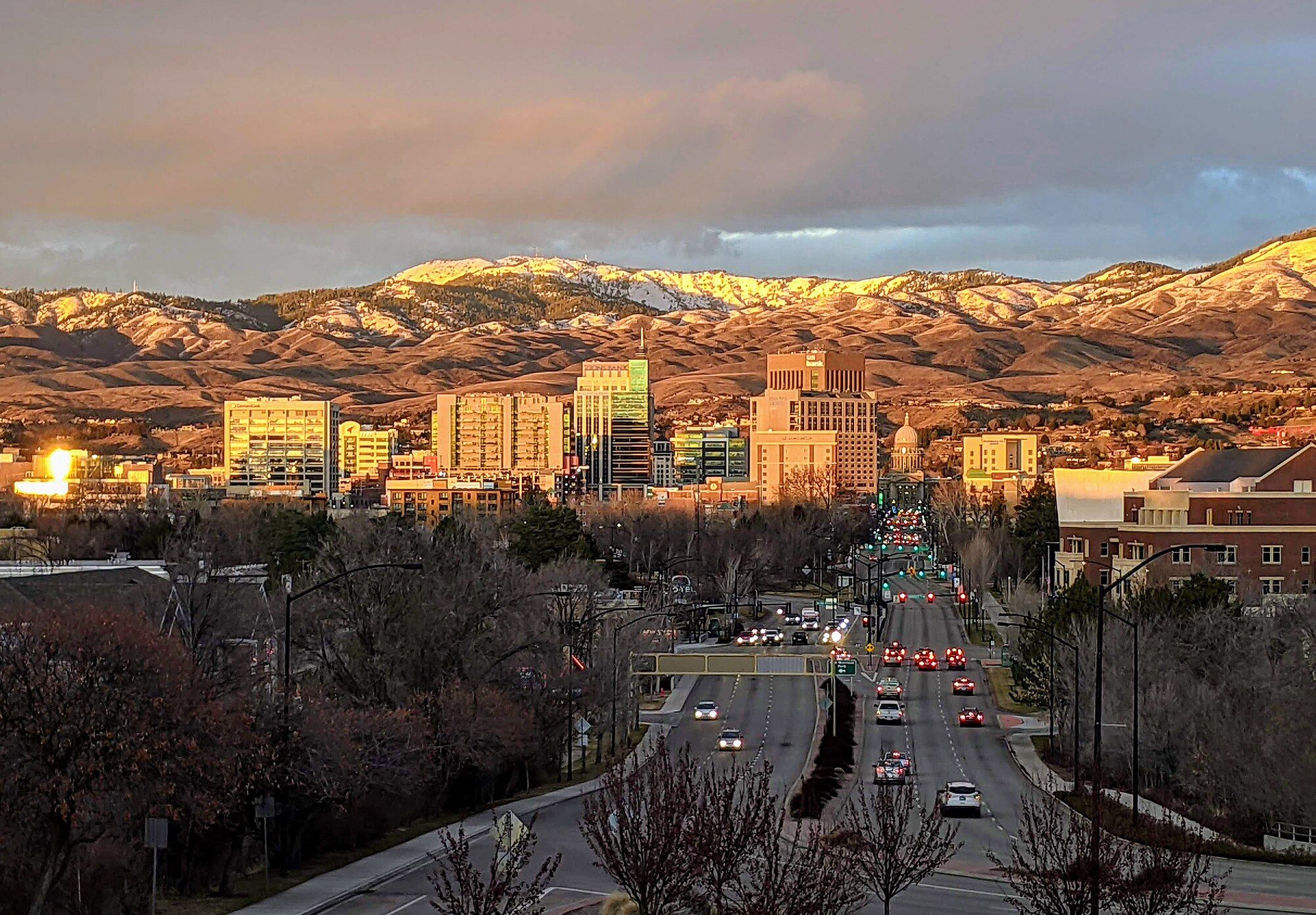 Downtown Boise skyline at sunset with the snow-dusted foothills behind